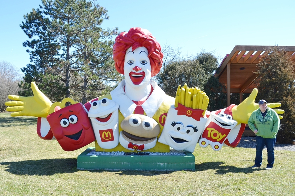 Giant Ronald McDonald Statue with woman standing nearby laughing