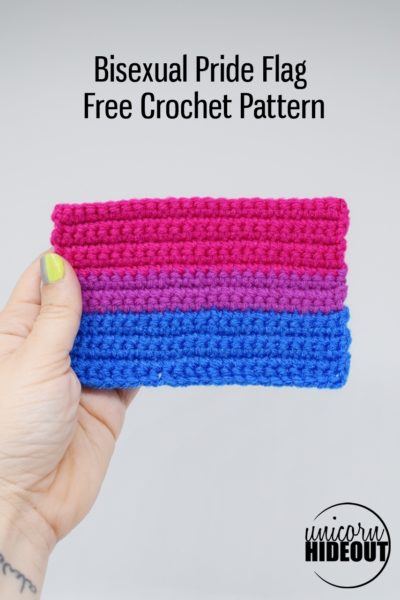 Hand holding a crochet bisexual pride flag, words on image: "Bisexual pride flag, free crochet pattern, Unicorn Hideout"