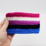 Hand holding Crochet genderfluid pride flag