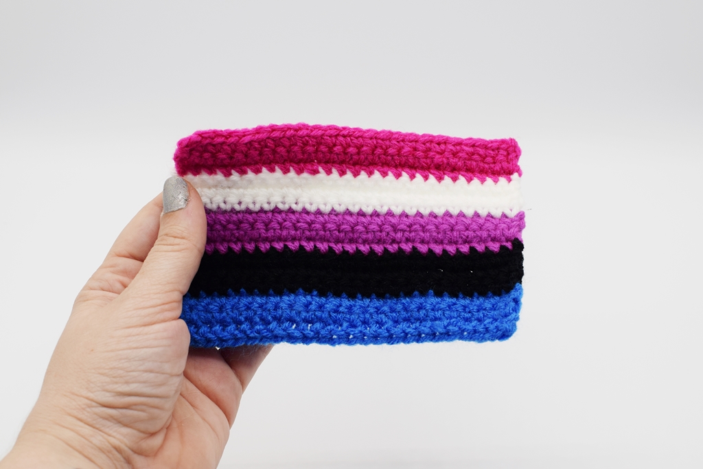 Hand holding Crochet genderfluid pride flag