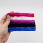 Hand holding Crochet genderfluid pride flag