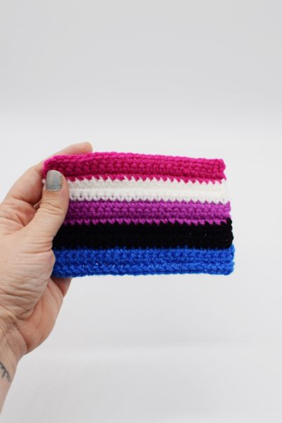 Hand holding Crochet genderfluid pride flag