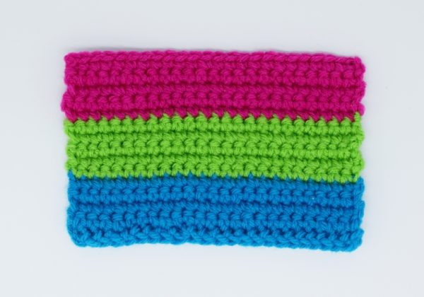 Crochet polysexual pride flag on a white background