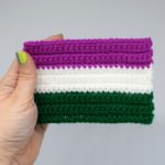 Hand holding Mini Crochet Genderqueer Pride Flag on white background