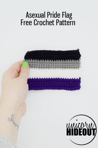 hand holding a crochet asexual pride flag, words on image say "asexual pride flag free crochet pattern, unicorn hideout"