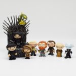 A mini iron throne and nine funko pop Game of Thrones mystery minis around it