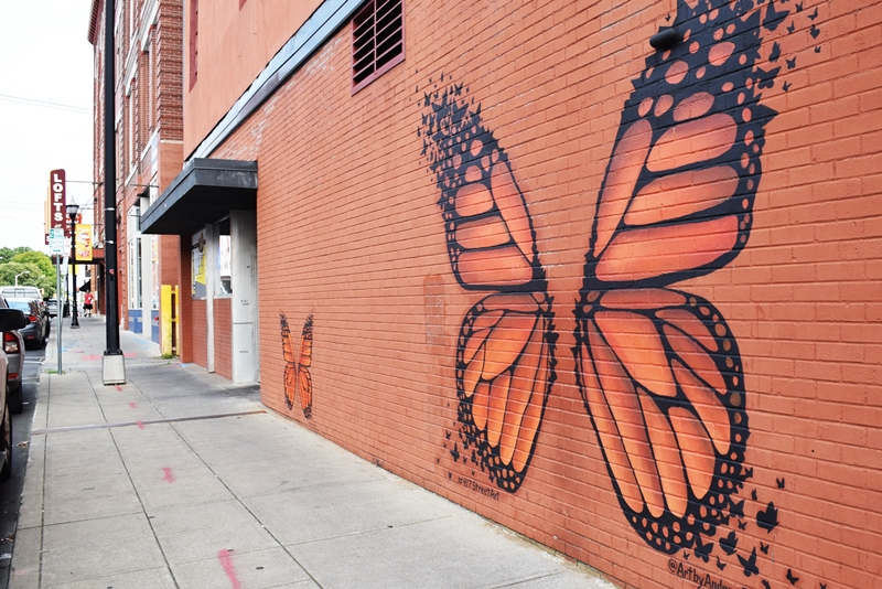 monarch butterfly wings painted on a brick wall